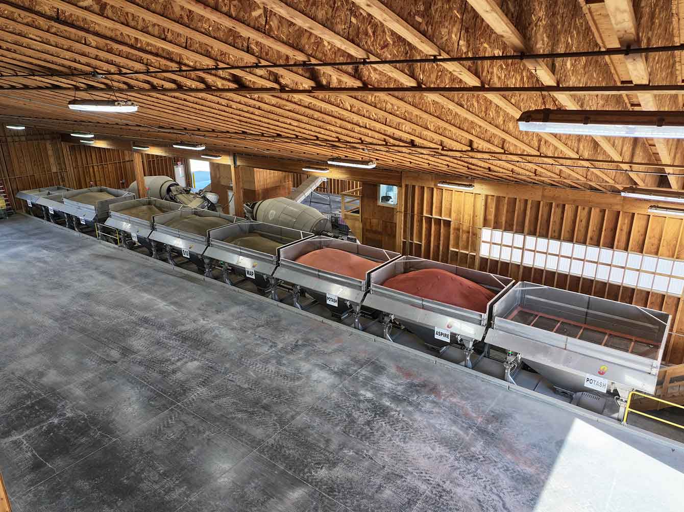 Dual 13-ton Rotary Blender AUTOBATCH blend system loading two dry fertilizer tender trucks at the same time