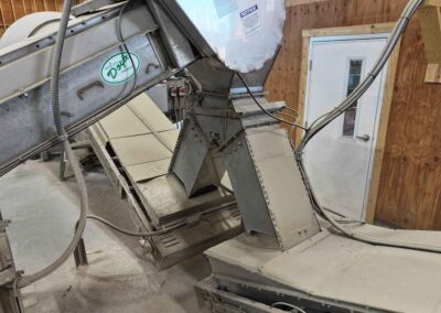 Central transfer conveyor with a Y-valve for directing material to either the left or right blender, or bypassing the blender to unload straight product into either loadout lane